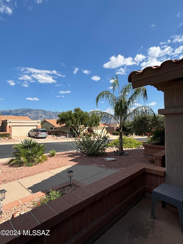 view of patio with a mountain view and a garage