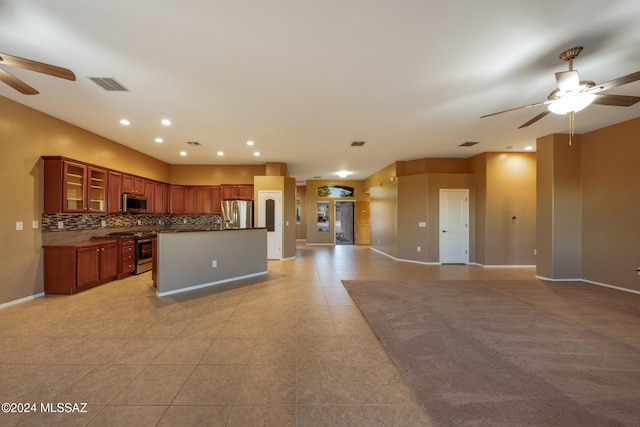 kitchen featuring decorative backsplash, appliances with stainless steel finishes, light tile patterned flooring, and ceiling fan