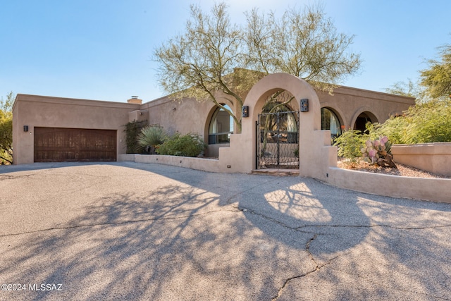 southwest-style home with a garage