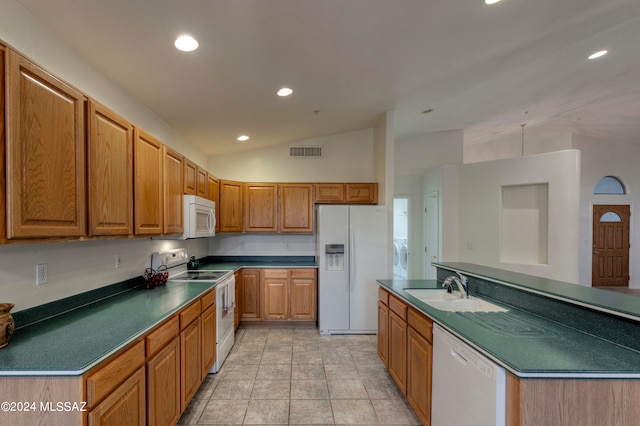 kitchen with light tile patterned floors, sink, vaulted ceiling, and white appliances