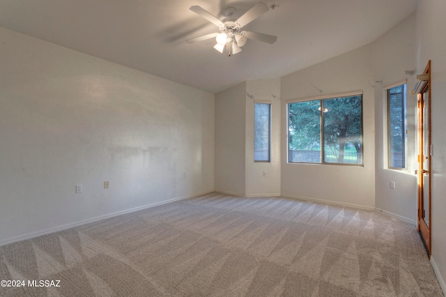 unfurnished room featuring light carpet, lofted ceiling, and ceiling fan