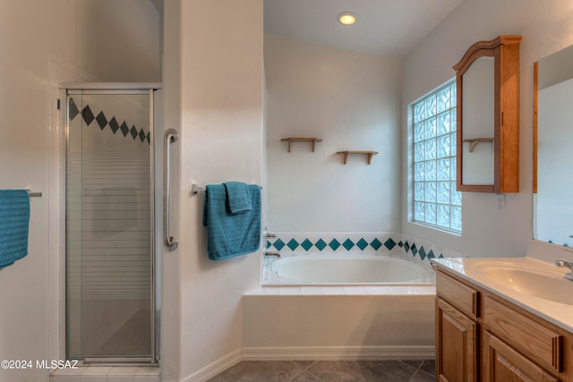 bathroom with lofted ceiling, tile patterned floors, independent shower and bath, and vanity