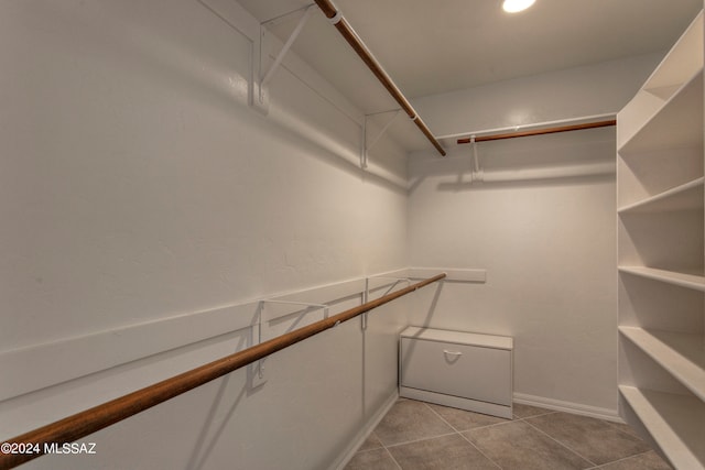 spacious closet featuring light tile patterned floors