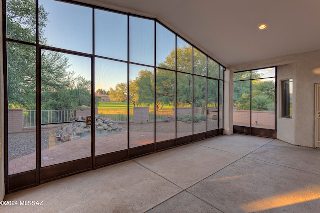 unfurnished sunroom featuring lofted ceiling