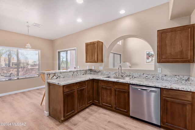 kitchen featuring hanging light fixtures, light wood-type flooring, sink, kitchen peninsula, and stainless steel dishwasher