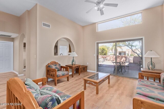 living room featuring ceiling fan and light hardwood / wood-style floors