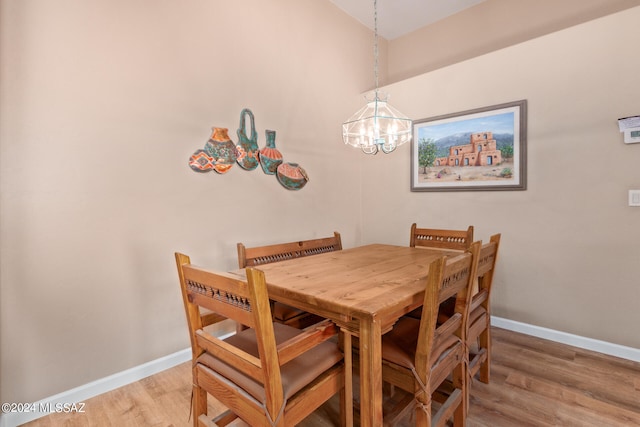 dining area featuring light hardwood / wood-style flooring and an inviting chandelier