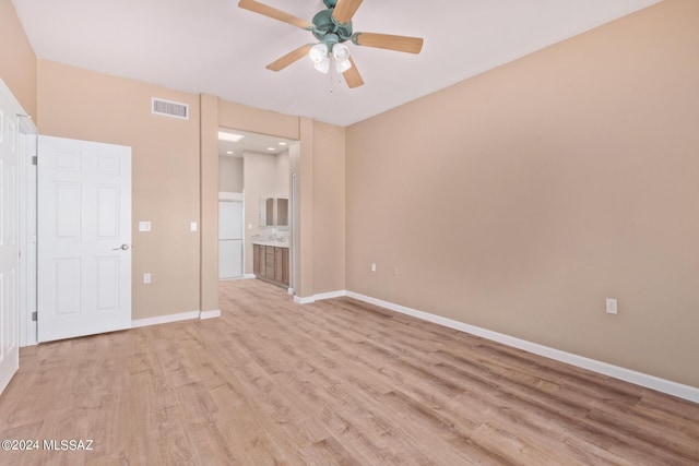 2521 S Pecan Valley Pl, Green Valley, AZ 85614 - unfurnished bedroom with light wood finished floors, baseboards, connected bathroom, and ceiling fan