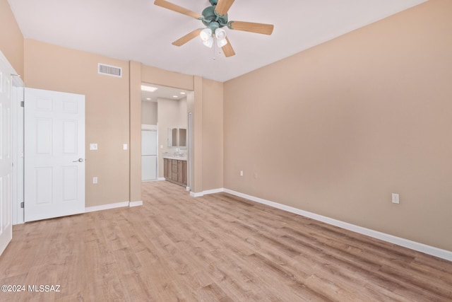 unfurnished bedroom featuring connected bathroom, ceiling fan, and light hardwood / wood-style floors