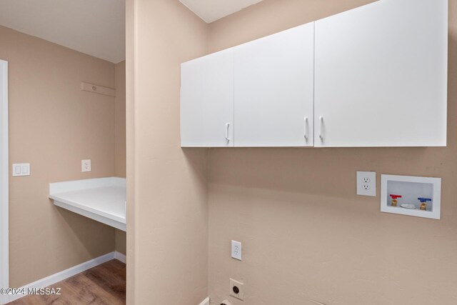 laundry area featuring washer hookup, hookup for an electric dryer, light hardwood / wood-style floors, and cabinets