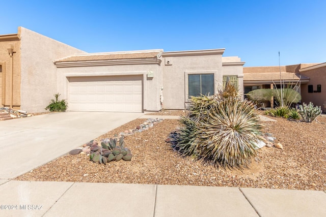 2521 S Pecan Valley Pl, Green Valley, AZ 85614 - adobe home featuring an attached garage, stucco siding, and concrete driveway