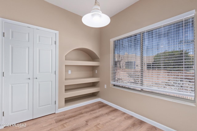 2521 S Pecan Valley Pl, Green Valley, AZ 85614 - unfurnished dining area featuring wood finished floors and baseboards