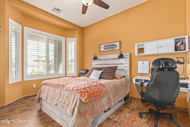 bedroom with visible vents, baseboards, and multiple windows