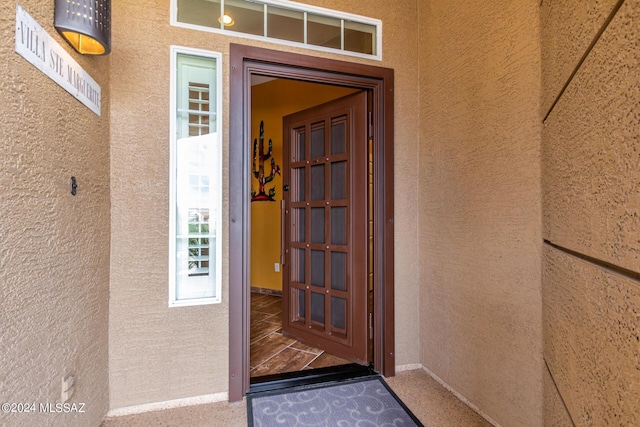 property entrance with stucco siding