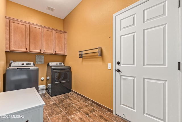 laundry area with cabinet space, baseboards, visible vents, and washing machine and dryer