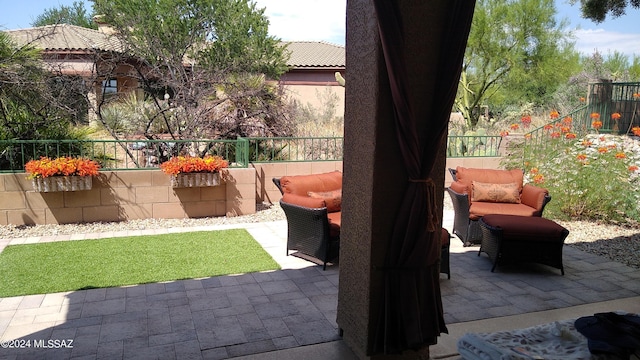 view of patio / terrace featuring an outdoor living space with a fire pit