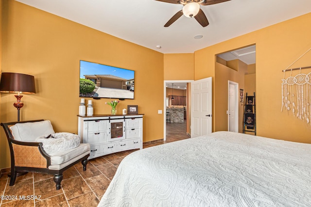 bedroom with a ceiling fan and baseboards
