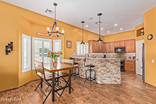 dining area featuring an inviting chandelier, recessed lighting, a towering ceiling, and visible vents