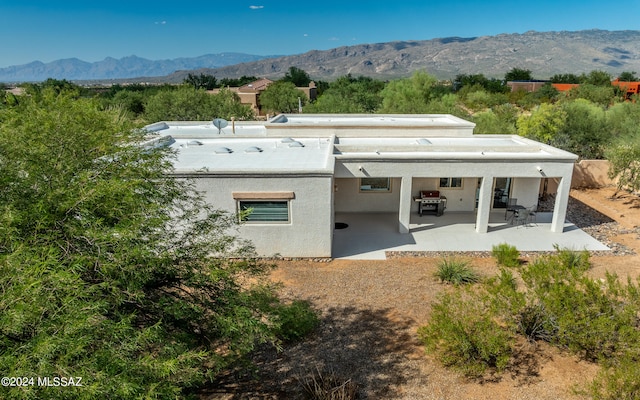 back of house with a patio and a mountain view