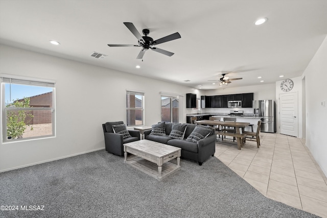living area featuring light tile patterned flooring, visible vents, recessed lighting, and a ceiling fan