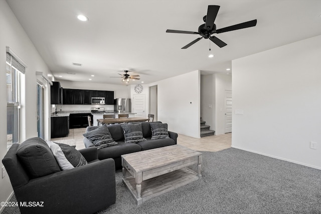 living room featuring light tile patterned flooring, stairs, recessed lighting, and a ceiling fan