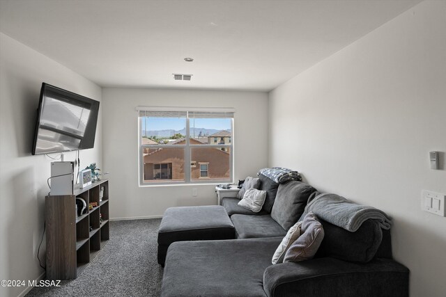 living room featuring baseboards, carpet floors, and visible vents