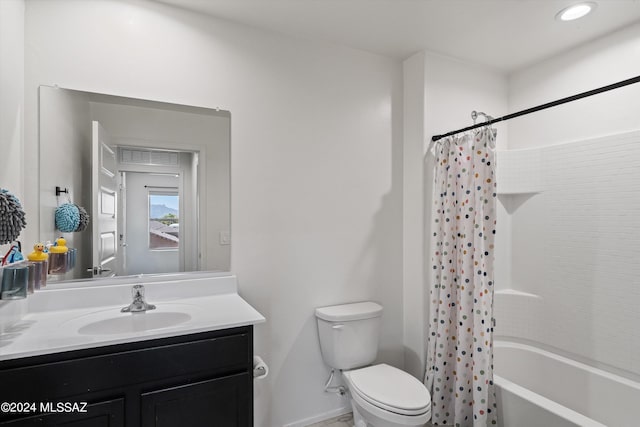 full bathroom with toilet, vanity, baseboards, and shower / tub combo