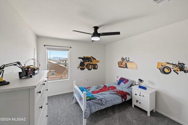 carpeted bedroom with baseboards, visible vents, and a ceiling fan