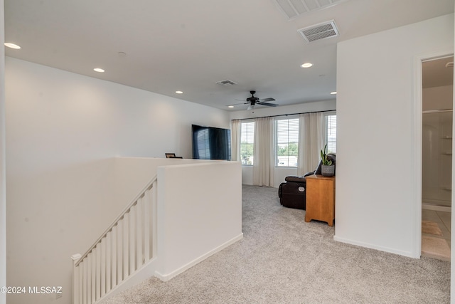 hallway with light colored carpet