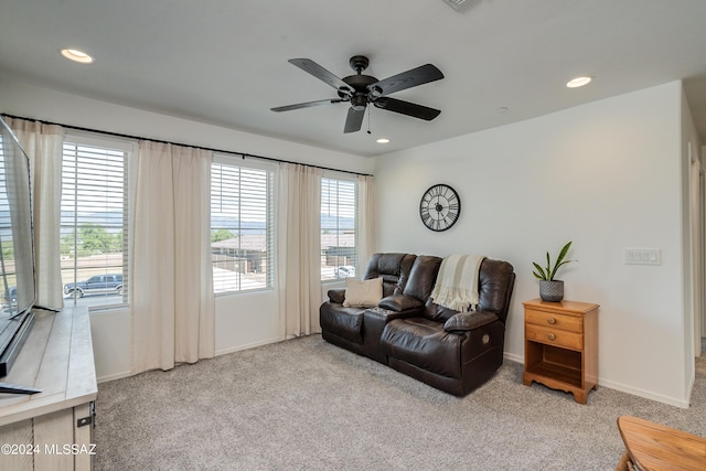 living room with ceiling fan and light colored carpet