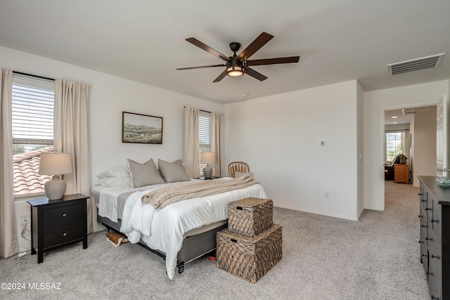 bedroom featuring light colored carpet and ceiling fan