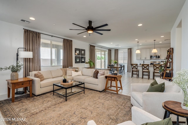 living room with ceiling fan and light tile patterned floors