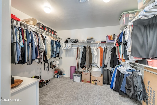 walk in closet featuring carpet flooring