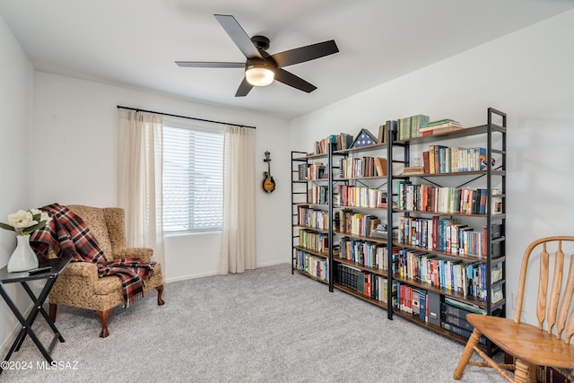 sitting room featuring ceiling fan and light colored carpet