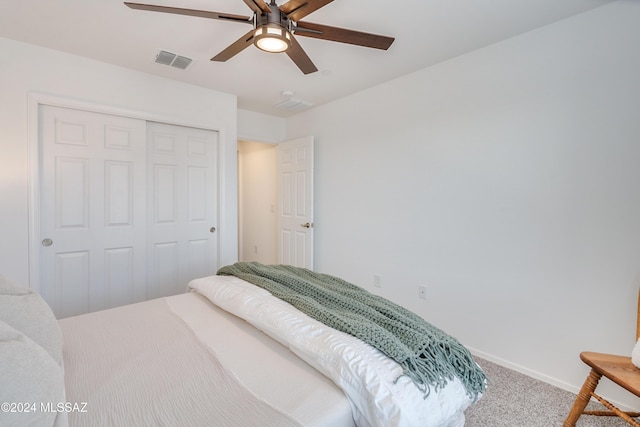 bedroom featuring ceiling fan, a closet, and carpet