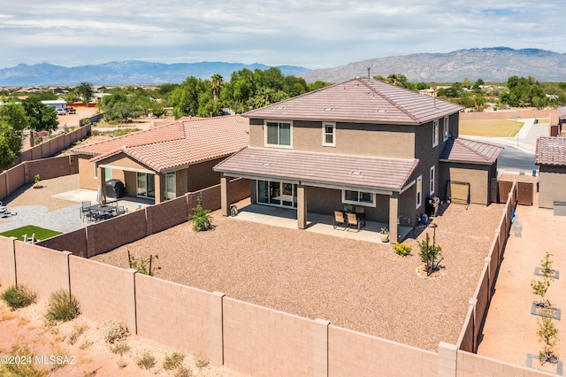 view of front of house with a patio area and a mountain view