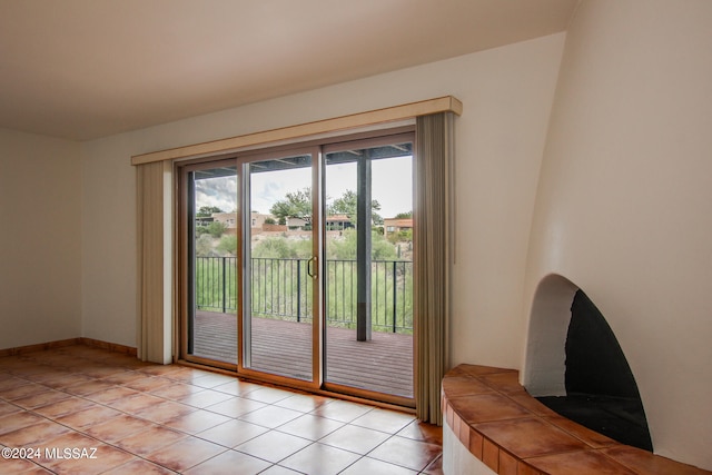 doorway to outside with light tile patterned floors