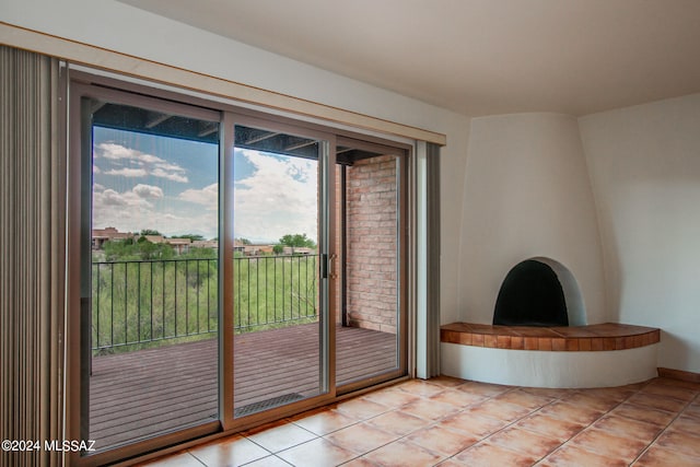 entryway with a healthy amount of sunlight and light tile patterned floors