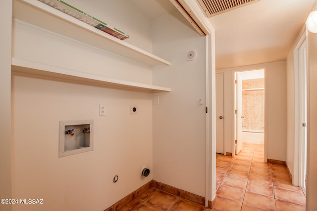 clothes washing area featuring hookup for a washing machine, hookup for a gas dryer, light tile patterned floors, and hookup for an electric dryer