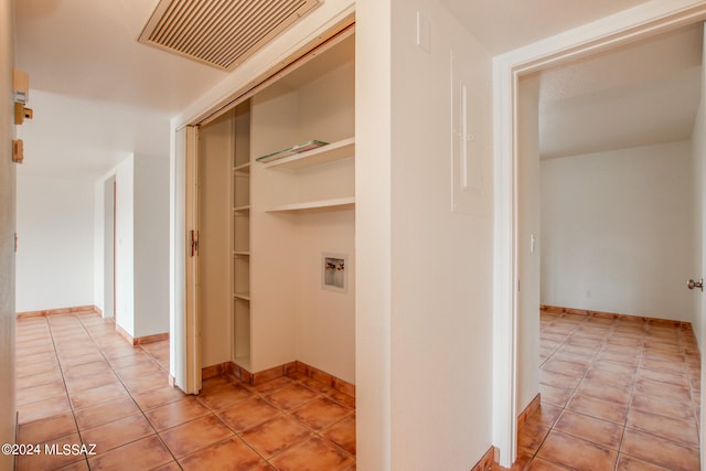 hall with light tile patterned floors