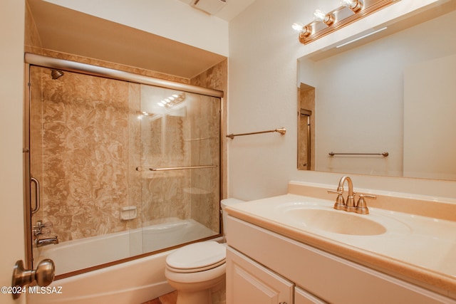 full bathroom with shower / bath combination with glass door, vanity, and toilet