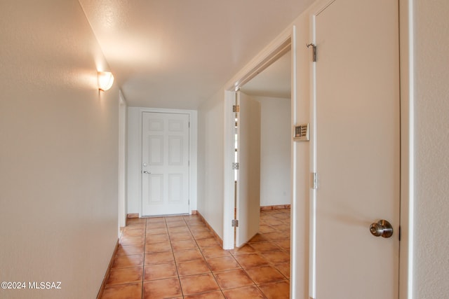 hall featuring light tile patterned floors