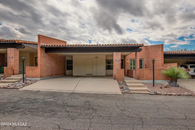 mediterranean / spanish house with a carport