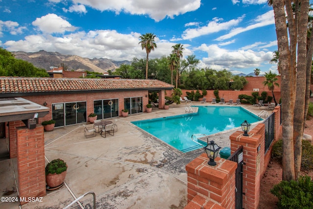 view of swimming pool featuring a mountain view and a patio area