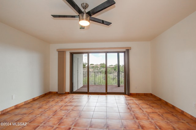 tiled spare room featuring ceiling fan