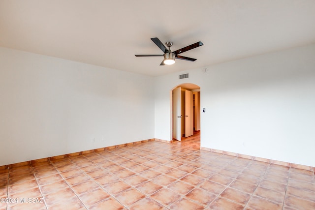 tiled empty room with ceiling fan