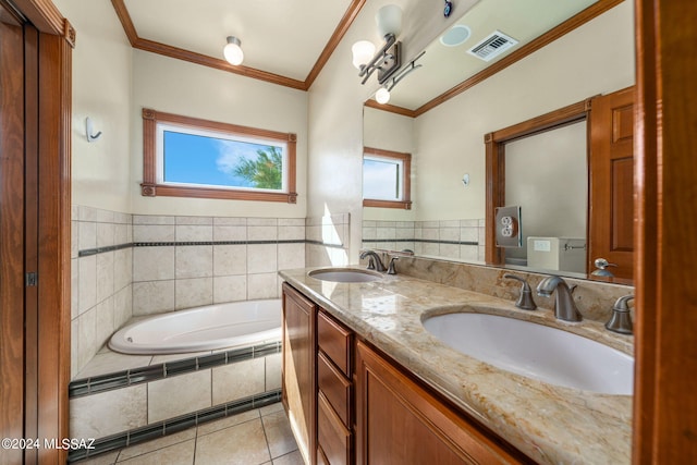 bathroom featuring crown molding, vanity, tiled tub, and tile patterned floors