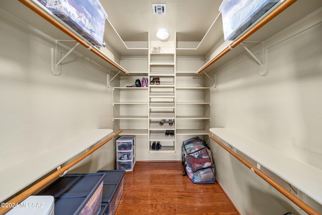 spacious closet featuring hardwood / wood-style floors