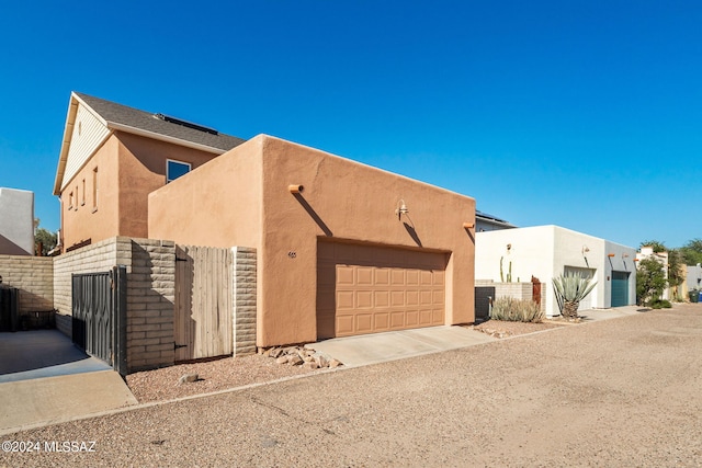 pueblo revival-style home with a garage