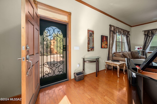 foyer featuring hardwood / wood-style flooring and ornamental molding